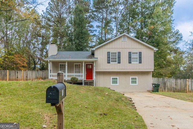 split level home featuring a front lawn and covered porch