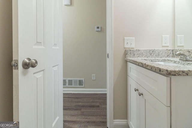 bathroom with vanity and hardwood / wood-style flooring