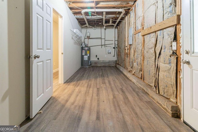 basement with electric water heater, hardwood / wood-style flooring, and electric panel