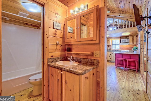 full bathroom featuring wood walls, vanity, wood ceiling, and hardwood / wood-style floors