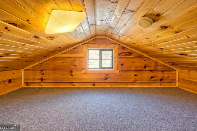 additional living space with wood walls, vaulted ceiling, wooden ceiling, and carpet flooring