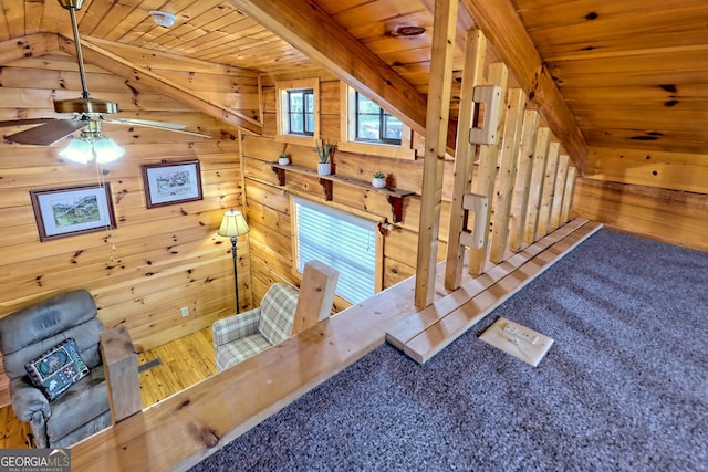 interior details featuring wooden ceiling, ceiling fan, wooden walls, and hardwood / wood-style floors