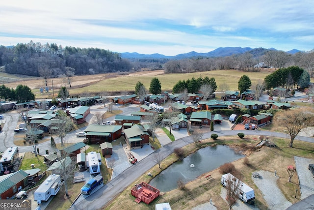 birds eye view of property featuring a water and mountain view