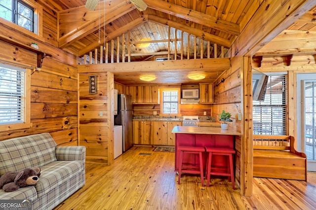 kitchen featuring wood walls, wooden ceiling, and light hardwood / wood-style flooring