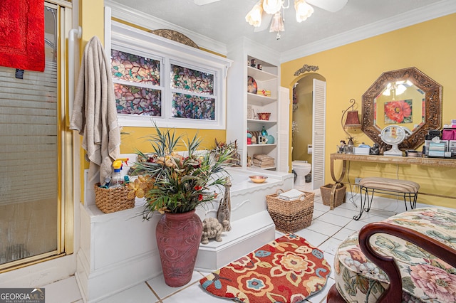 sitting room with a textured ceiling, light tile patterned floors, crown molding, and ceiling fan