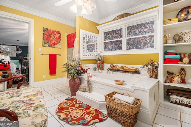 bathroom featuring tile patterned flooring, a textured ceiling, ceiling fan, crown molding, and a tub to relax in