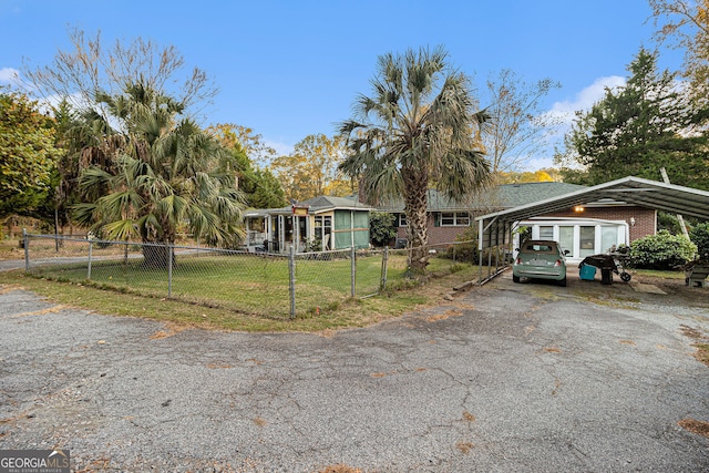 view of front of home with a front yard and a carport