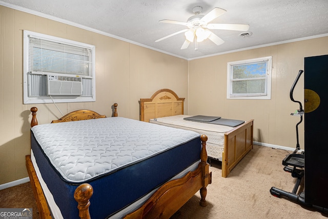 bedroom featuring ceiling fan, ornamental molding, a textured ceiling, and light colored carpet