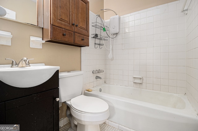 full bathroom with vanity, tile patterned flooring, toilet, and tiled shower / bath