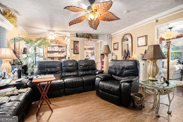 living room with light wood-type flooring, a textured ceiling, crown molding, and ceiling fan