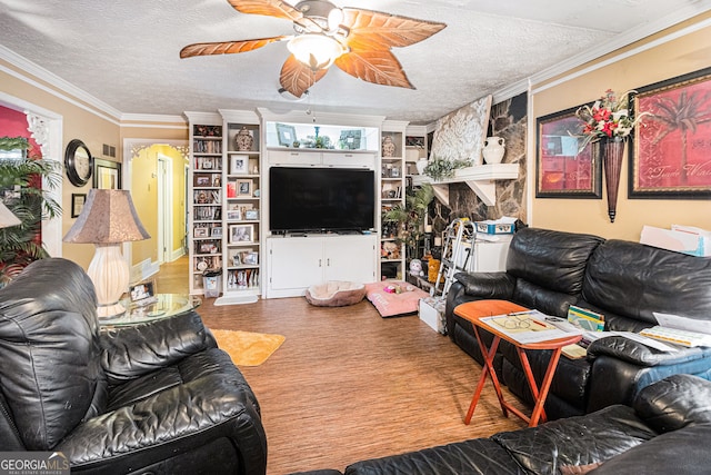 living room with hardwood / wood-style flooring, ornamental molding, and a textured ceiling