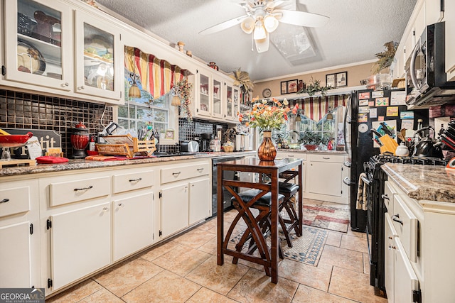 kitchen featuring black appliances, backsplash, a textured ceiling, light stone countertops, and white cabinets