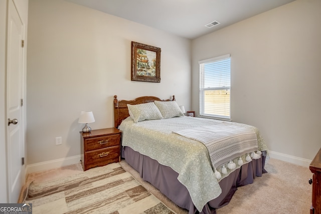 bedroom featuring light carpet