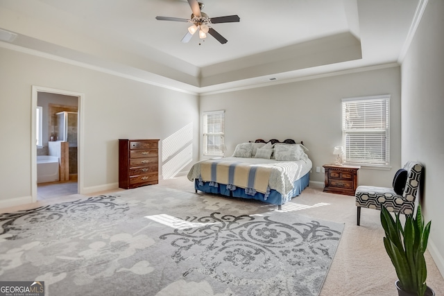 carpeted bedroom featuring ensuite bathroom, ceiling fan, a raised ceiling, and crown molding