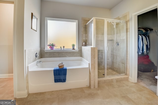 bathroom with tile patterned flooring, plenty of natural light, and plus walk in shower