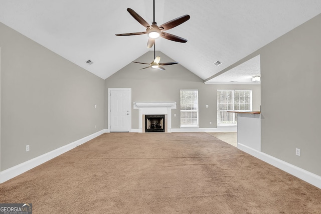 unfurnished living room with light carpet, ceiling fan, and vaulted ceiling