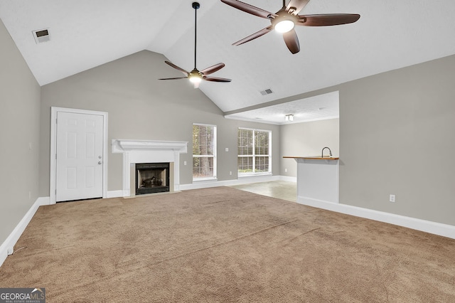 unfurnished living room featuring high vaulted ceiling, carpet, and ceiling fan