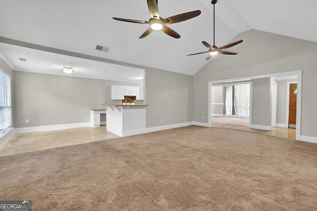 unfurnished living room featuring ceiling fan, light carpet, and a healthy amount of sunlight