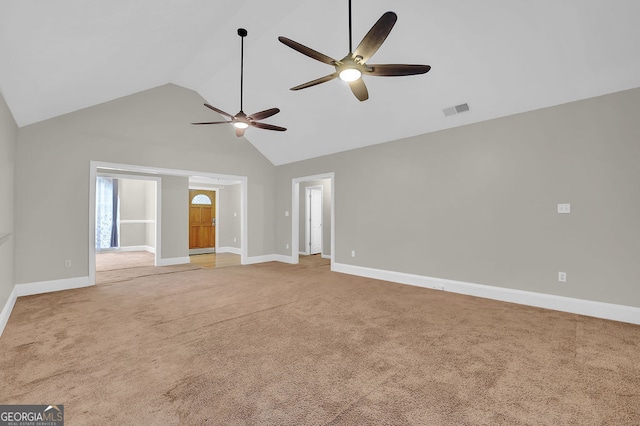 spare room with ceiling fan, high vaulted ceiling, and carpet