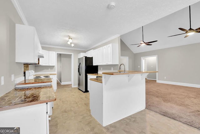 kitchen featuring crown molding, stainless steel refrigerator with ice dispenser, a breakfast bar, white cabinets, and kitchen peninsula