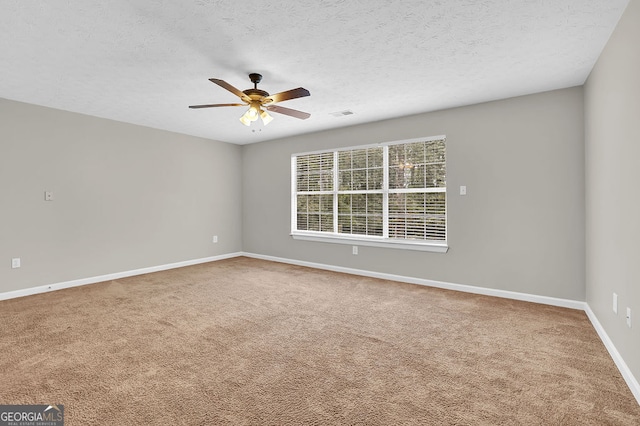 carpeted empty room featuring a textured ceiling and ceiling fan