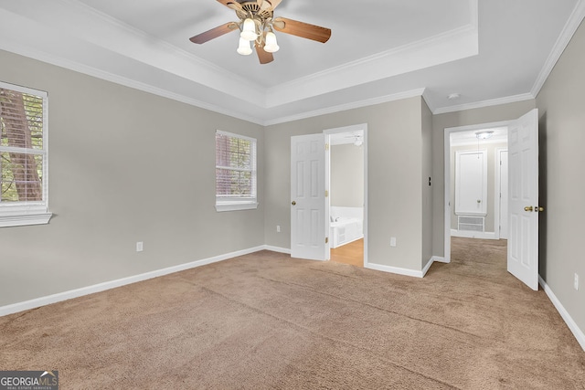 unfurnished bedroom with ceiling fan, multiple windows, crown molding, and light colored carpet