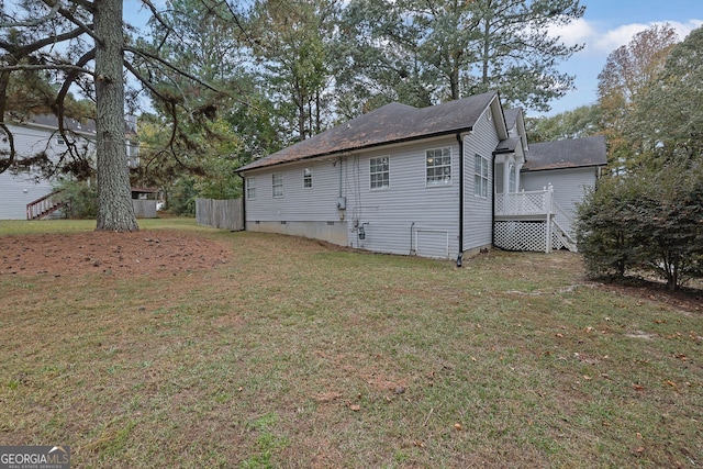 view of home's exterior with a yard