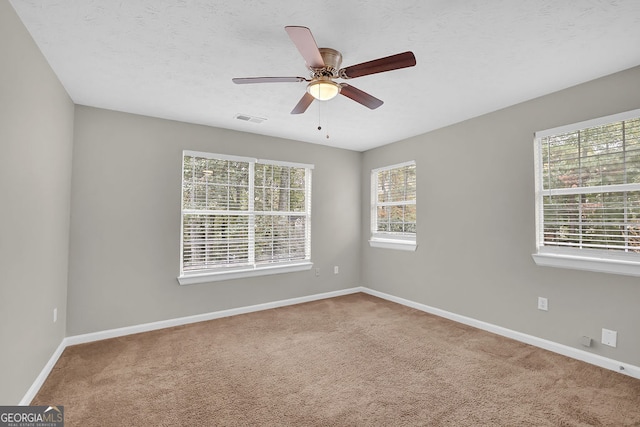 unfurnished room with ceiling fan and carpet floors