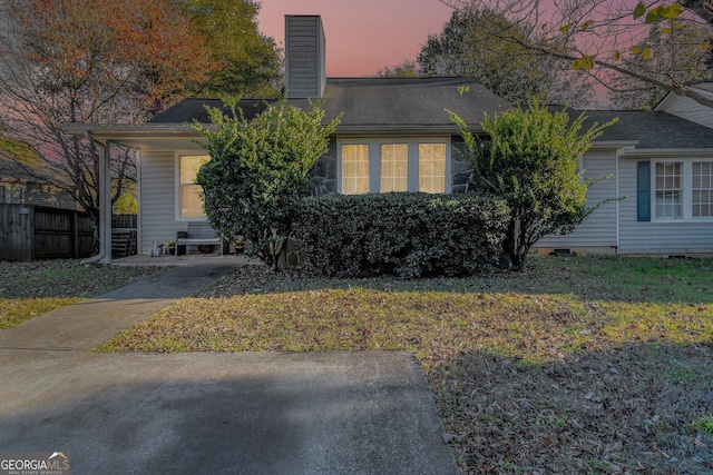 view of front of house featuring fence and a chimney