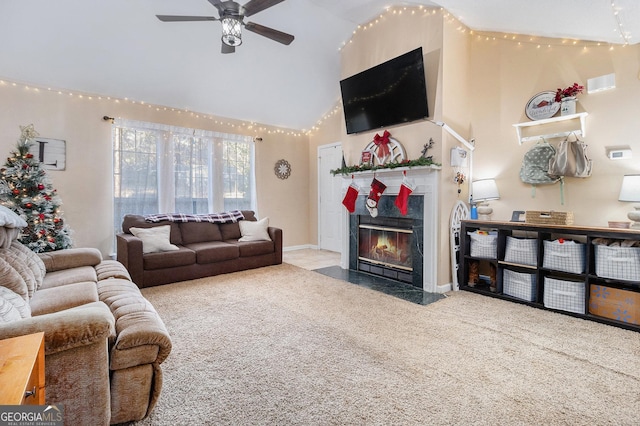 living area featuring visible vents, ceiling fan, a fireplace with flush hearth, carpet, and high vaulted ceiling