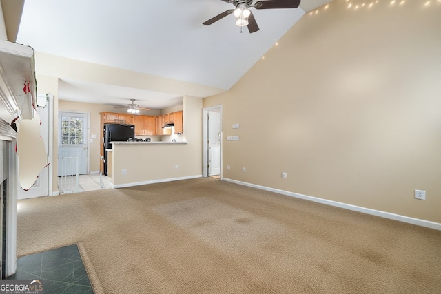 unfurnished living room featuring a ceiling fan, light colored carpet, and baseboards