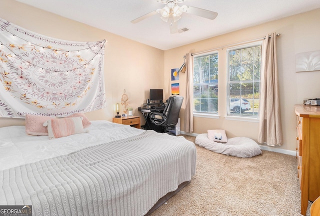 bedroom featuring carpet, baseboards, visible vents, and ceiling fan