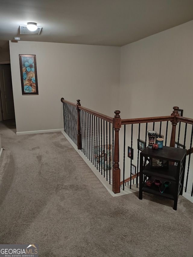 interior space with baseboards, visible vents, and carpet flooring