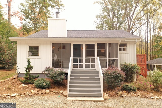 view of outbuilding featuring a sunroom