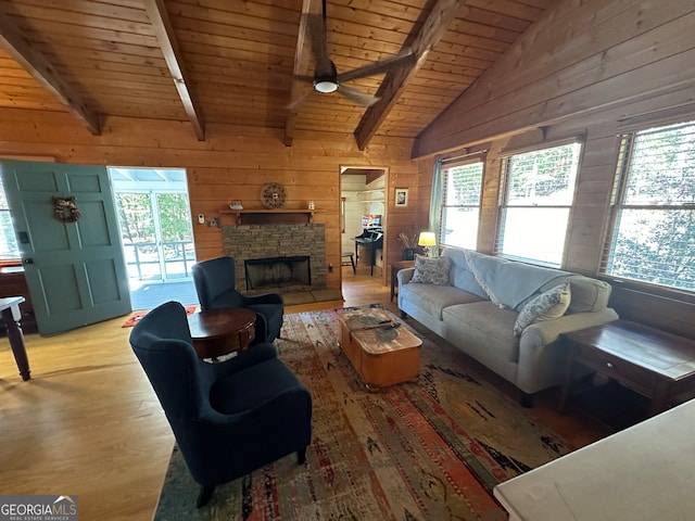 living room with wood walls, wooden ceiling, lofted ceiling with beams, ceiling fan, and light wood-type flooring