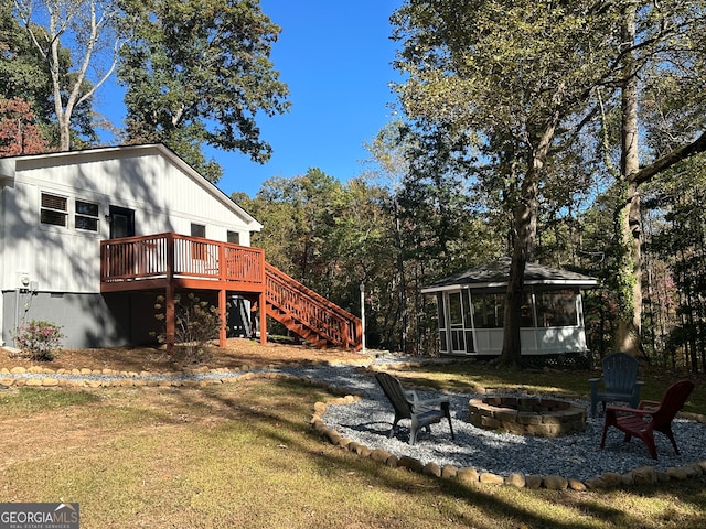 view of yard with a fire pit and a deck