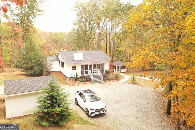 view of front of house featuring covered porch and a sunroom