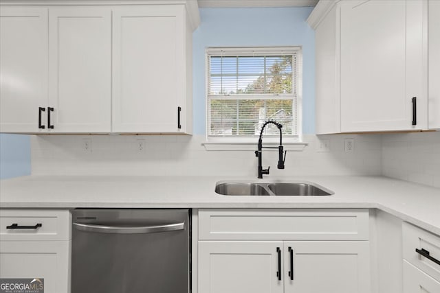 kitchen with dishwasher, tasteful backsplash, white cabinets, and sink