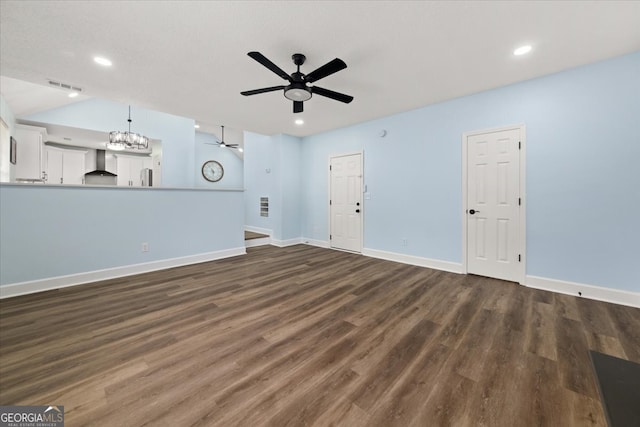 unfurnished living room with dark wood-type flooring and ceiling fan with notable chandelier