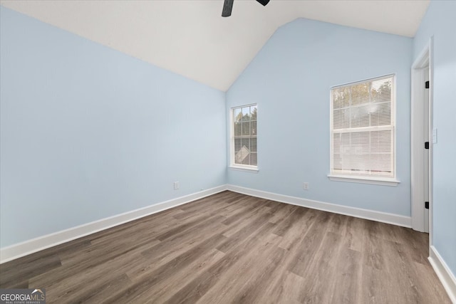 unfurnished room with light wood-type flooring, plenty of natural light, ceiling fan, and vaulted ceiling