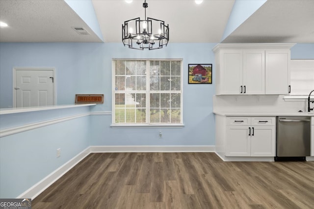 unfurnished dining area with dark hardwood / wood-style floors, a chandelier, and lofted ceiling