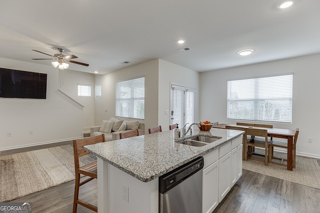 kitchen with a wealth of natural light, white cabinetry, dishwasher, and dark hardwood / wood-style floors