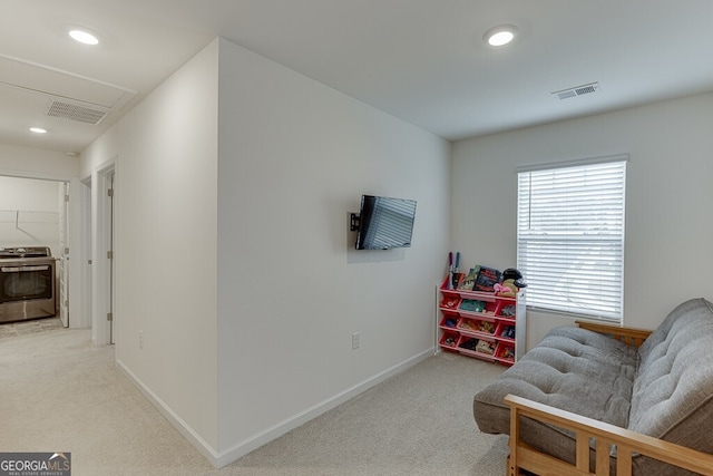 sitting room featuring light colored carpet