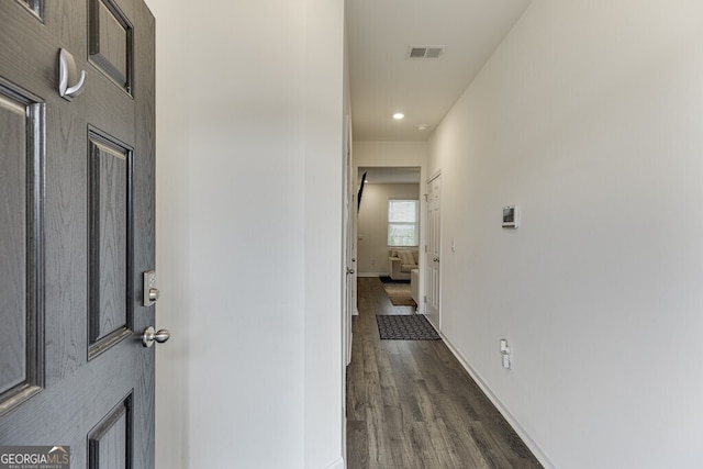 hall with dark hardwood / wood-style floors