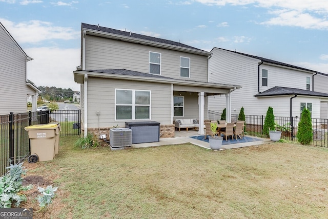 rear view of property with a lawn, central air condition unit, and a patio