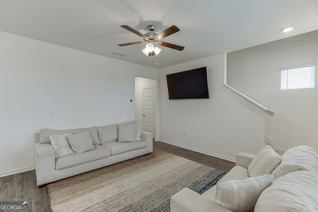 living room featuring dark hardwood / wood-style floors and ceiling fan