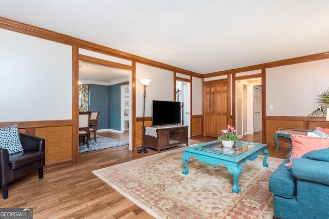 living room featuring hardwood / wood-style flooring and ornamental molding