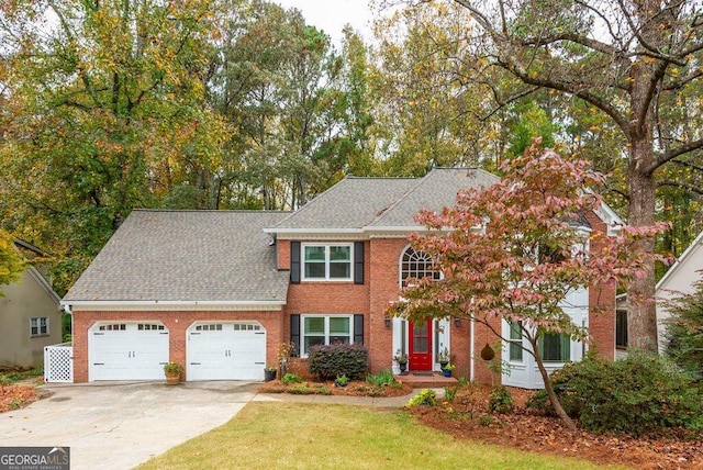 colonial-style house featuring a front lawn and a garage