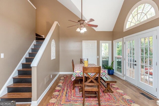 dining area featuring high vaulted ceiling, ceiling fan, french doors, and light hardwood / wood-style floors