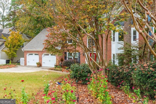 view of front of property with a garage and a front lawn